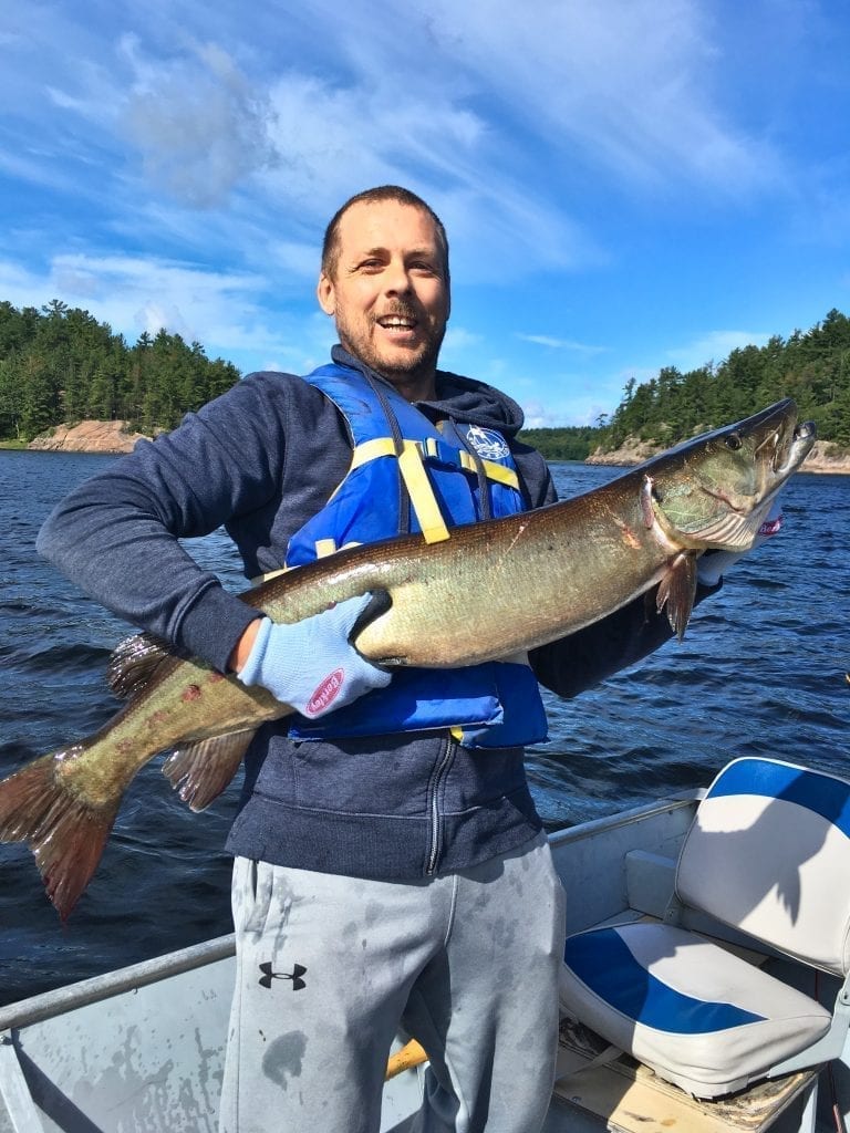 Fishing French River Musky at 44 inches, caught and released by father and son.