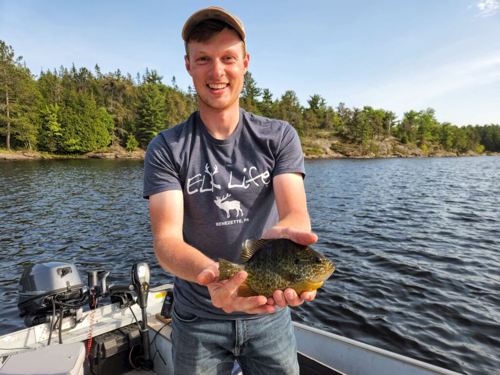 Colt M. holding a French River Pumpkinseed panfish.  