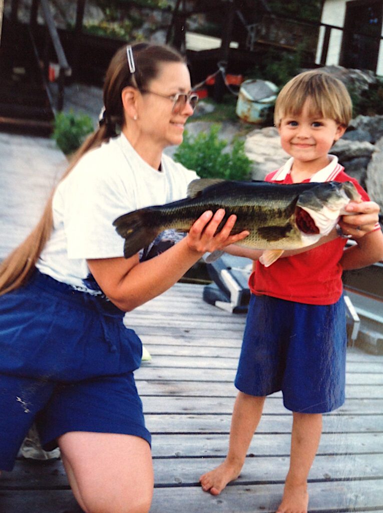Lady and son holding a Largemouth Bass Experience Fishing in French River, Northern Ontario