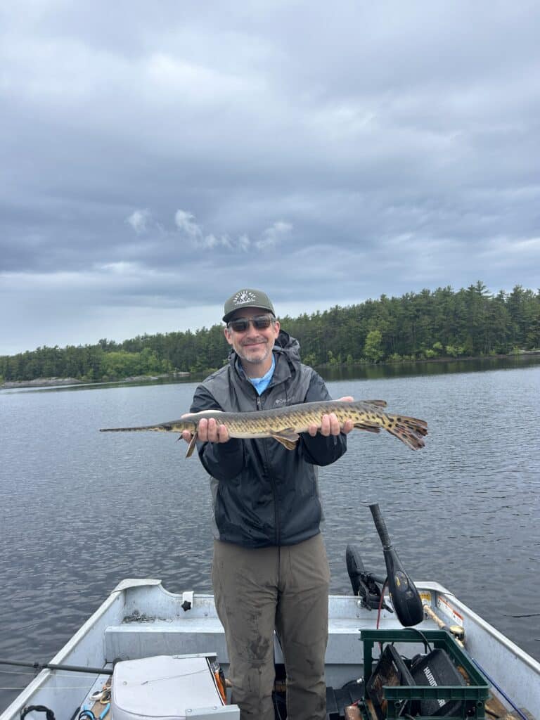 Matt Gray holding a spring Longnose Gar on the French River